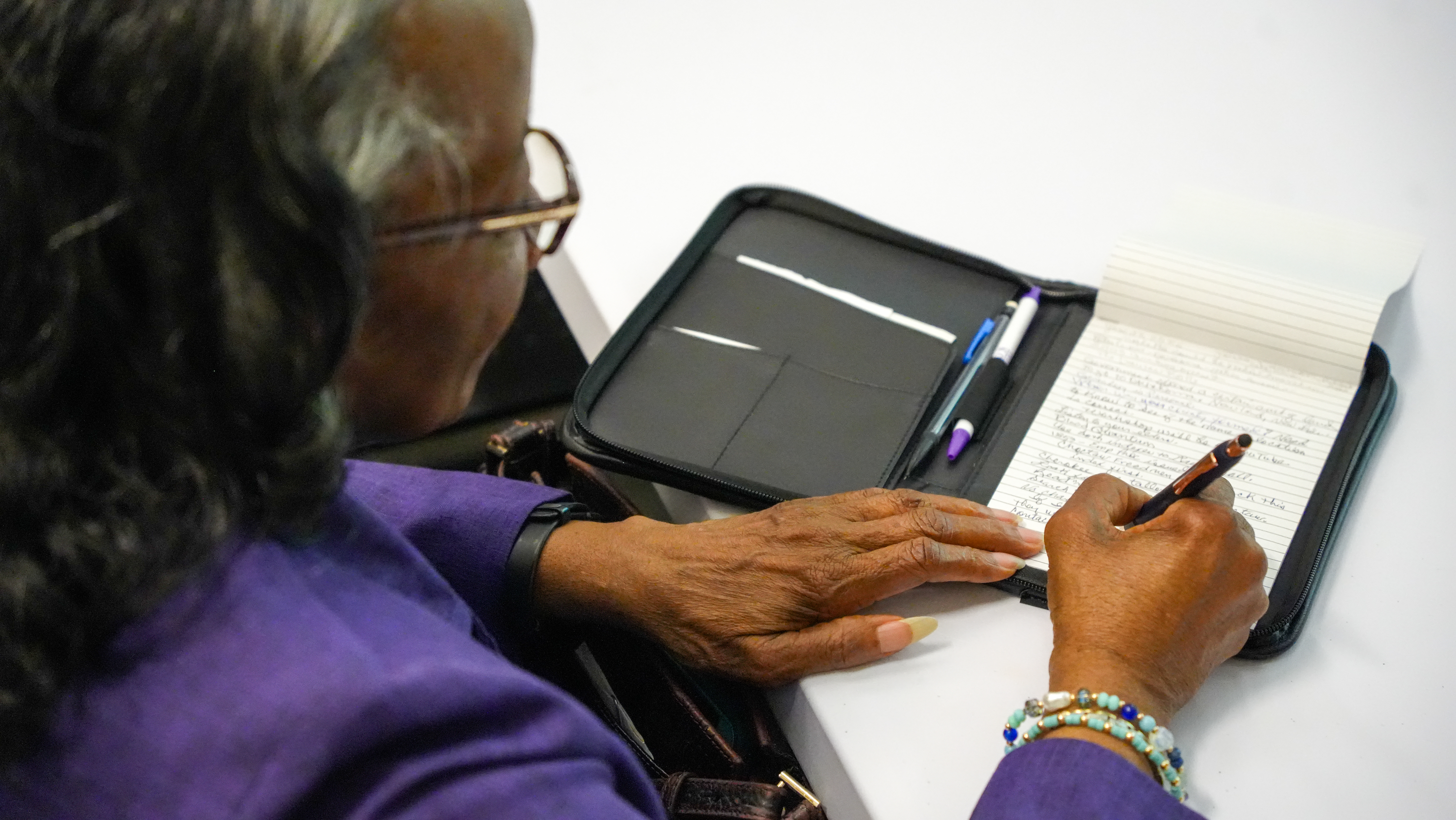 A participant writing notes