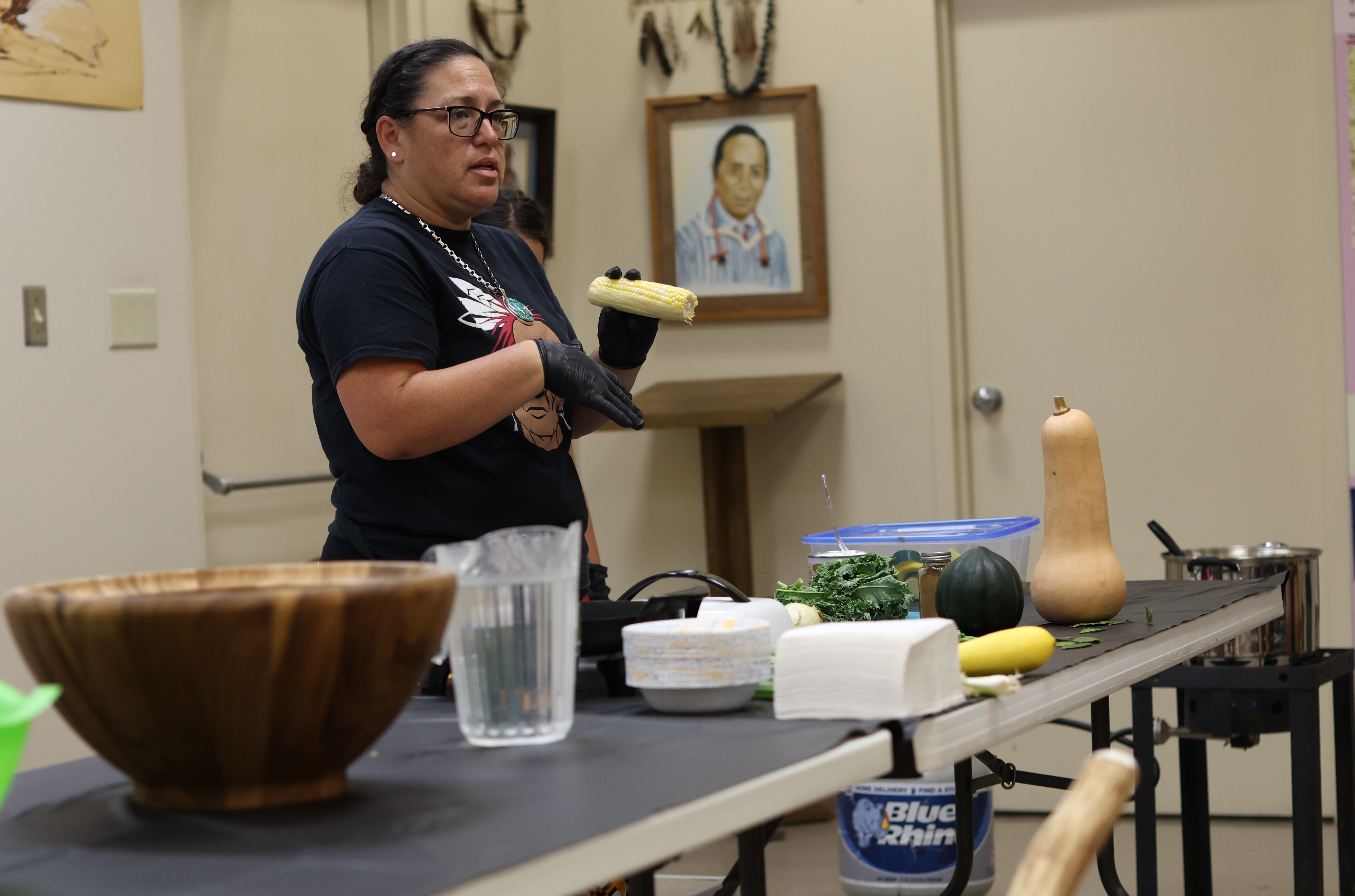 Rebekah Scott holds corn during cooking demonstration