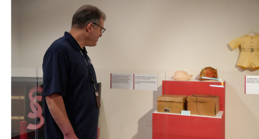 Jeff looking at his dad's credit card on display in Mississippi Made